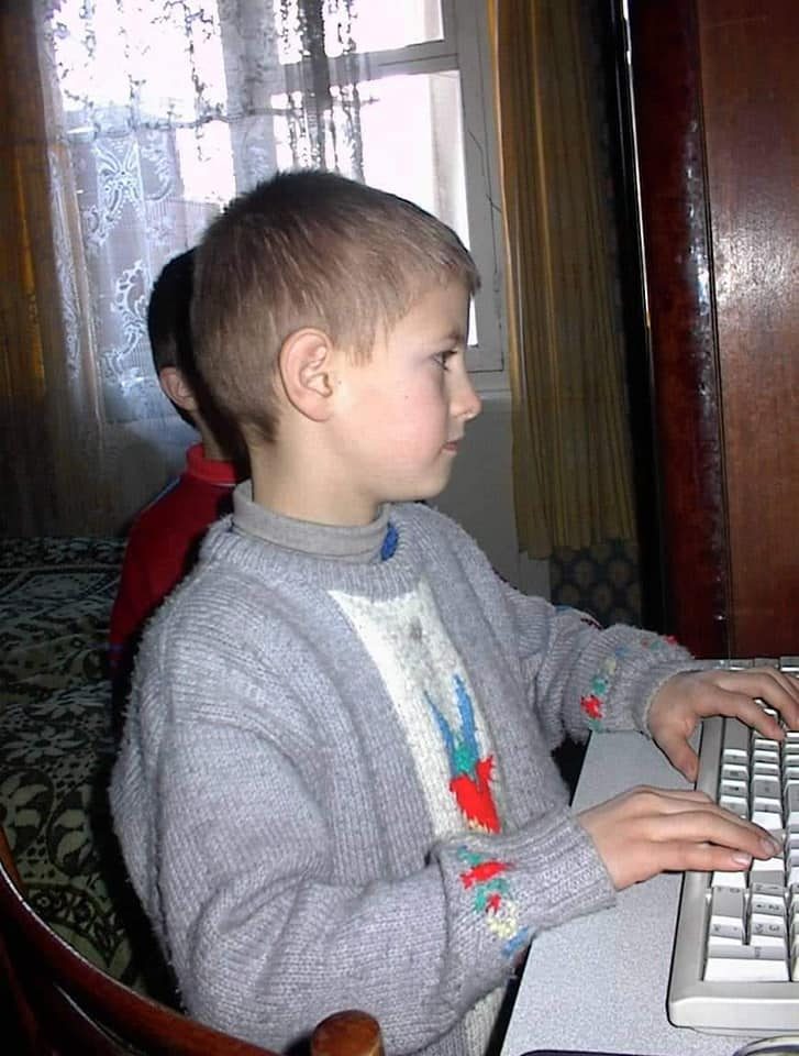 Rez as a young boy typing at a computer keyboard
